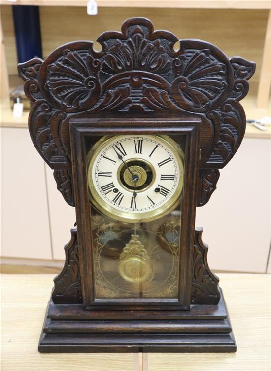 An American dark oak mantel clock, with bell striking movement, height 56cm